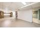 Unfinished basement area with cabinets, access to the stairs, and door to another room at 1495 S Chase Ct, Lakewood, CO 80232