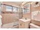 Neutral bathroom featuring tub with shower, framed mirror, and white vanity at 1495 S Chase Ct, Lakewood, CO 80232