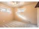 Comfortable bedroom with soft carpet, two windows for natural light, and neutral walls at 1495 S Chase Ct, Lakewood, CO 80232