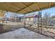 Covered patio area with concrete flooring and decorative water fountain at 1495 S Chase Ct, Lakewood, CO 80232