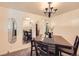 Dining room with wood table, black chairs, and classic chandelier lighting at 1495 S Chase Ct, Lakewood, CO 80232