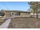 Charming brick home with well-kept lawn and tidy landscaping at 1495 S Chase Ct, Lakewood, CO 80232