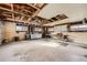 Spacious garage with exposed beams, work bench and storage at 1495 S Chase Ct, Lakewood, CO 80232