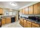 Functional kitchen with ample counter space and natural wood cabinetry at 1495 S Chase Ct, Lakewood, CO 80232