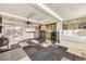 Unique living area with an artistic patchwork-style floor, fireplace, wet bar, and sliding glass doors at 1495 S Chase Ct, Lakewood, CO 80232