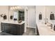 Double vanity bathroom with a large mirror and modern finishes at 14204 W 88Th Dr # C, Arvada, CO 80005