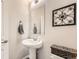 Small bathroom with pedestal sink and decorative accents at 14204 W 88Th Dr # C, Arvada, CO 80005