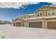 Townhouses with attached garages and snow covered driveways at 14204 W 88Th Dr # C, Arvada, CO 80005