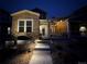 Night view of townhome exterior with pathway lighting at 14204 W 88Th Dr # C, Arvada, CO 80005