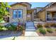 Stone and wood exterior of townhome with landscaping at 14204 W 88Th Dr # C, Arvada, CO 80005