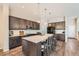 Open concept kitchen featuring a large island and dark wood cabinets at 14204 W 88Th Dr # C, Arvada, CO 80005