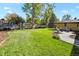 Expansive backyard with lush lawn, mature trees, play set, and patio area great for outdoor activities at 6392 S Lafayette St, Centennial, CO 80121