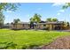 Large, well-maintained backyard with a patio, grassy area, and mature trees provides ample space for outdoor enjoyment at 6392 S Lafayette St, Centennial, CO 80121
