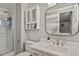 Bright bathroom featuring a glass-enclosed shower, white vanity, and modern fixtures at 6392 S Lafayette St, Centennial, CO 80121