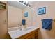 Classic bathroom with wood cabinets, large mirror, and ample lighting at 6392 S Lafayette St, Centennial, CO 80121