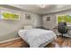 Cozy bedroom with a large bed, modern desk, and ample natural light from two windows at 6392 S Lafayette St, Centennial, CO 80121