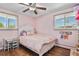 Charming pink bedroom with a decorative bed, ceiling fan, and hardwood floors at 6392 S Lafayette St, Centennial, CO 80121