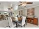 Open dining area featuring a large mirror, ceiling fan, and direct access to backyard patio at 6392 S Lafayette St, Centennial, CO 80121
