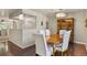 Charming dining room features a wood table, white chairs, and elegant chandelier lighting at 6392 S Lafayette St, Centennial, CO 80121