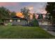Charming brick home featuring a manicured lawn, mature trees, and a spacious two-car garage at 6392 S Lafayette St, Centennial, CO 80121
