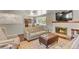 Open-concept living space with hardwood floors, fireplace, and access to the dining area at 6392 S Lafayette St, Centennial, CO 80121