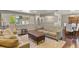 Living room featuring hardwood floors, large windows, and open access to the dining room at 6392 S Lafayette St, Centennial, CO 80121