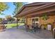 Inviting covered patio featuring dining set and a well-manicured lawn perfect for outdoor relaxation and entertaining at 6392 S Lafayette St, Centennial, CO 80121