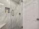 Updated shower featuring marble tiles, a glass enclosure, and a built-in seat at 6392 S Lafayette St, Centennial, CO 80121