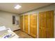 Shared storage area with window and multiple wooden doors at 2480 W Caithness Pl # 5, Denver, CO 80211