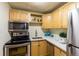 Well-equipped kitchen featuring stainless steel appliances and ample cabinetry at 2480 W Caithness Pl # 5, Denver, CO 80211