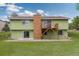 Exterior of the home featuring a deck and access to a spacious backyard at 7715 Estes Ct, Arvada, CO 80005