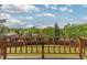 Expansive backyard view from the deck, featuring lush greenery and neighborhood homes at 7715 Estes Ct, Arvada, CO 80005