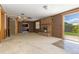 Cozy basement with a brick fireplace, open floor plan, and walk-out access to backyard at 7715 Estes Ct, Arvada, CO 80005