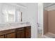Bathroom featuring a vanity with a marble countertop and tile shower at 7715 Estes Ct, Arvada, CO 80005