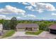 Charming single-Gathering home with green siding, a front-facing garage and landscaped front yard at 7715 Estes Ct, Arvada, CO 80005