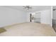 Bright living room with neutral carpet, ceiling fan, and an open layout at 7715 Estes Ct, Arvada, CO 80005