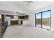 Open living space with a kitchen area featuring a breakfast bar and sliding glass doors to the deck at 7715 Estes Ct, Arvada, CO 80005