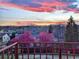 Scenic view of mountains and a colorful sunset over blooming trees from the deck at 7715 Estes Ct, Arvada, CO 80005
