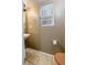 Compact half-bathroom featuring a pedestal sink, tiled floors, and toilet at 15333 E 98Th Pl, Commerce City, CO 80022