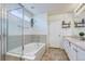 Cozy bathroom with tile floors, bathtub, shower and bright white cabinets at 15333 E 98Th Pl, Commerce City, CO 80022