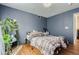 Cozy bedroom with elegant chandelier, blue walls, and hardwood floors at 15333 E 98Th Pl, Commerce City, CO 80022