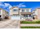 Charming two-story home featuring a two-car garage and a cozy front porch at 15333 E 98Th Pl, Commerce City, CO 80022