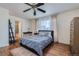 Comfortable main bedroom with ceiling fan, hardwood floors, and a large window at 15333 E 98Th Pl, Commerce City, CO 80022