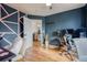 Inviting home office featuring stylish decor, wood floors, and comfortable seating at 15333 E 98Th Pl, Commerce City, CO 80022