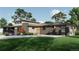 A modern home's exterior featuring a two-car garage, a flat roof, and a well-manicured lawn, perfect for suburban living at 1721 Arrowpoint Ct, Franktown, CO 80116
