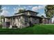 Modern home featuring stone accents and lots of windows with a well-kept lawn at 1721 Arrowpoint Ct, Franktown, CO 80116