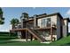 Modern home showcasing a two-story deck with metal railings and stone accents at 1721 Arrowpoint Ct, Franktown, CO 80116