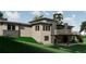 Contemporary house featuring stone accents, large windows, and manicured lawn at 1721 Arrowpoint Ct, Franktown, CO 80116