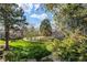 View of lawn and pool from back of property with large trees in the background at 2690 E Otero Pl # 7, Centennial, CO 80122