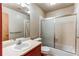 Bathroom with a vanity sink, toilet, and shower-tub with a glass door at 2690 E Otero Pl # 7, Centennial, CO 80122